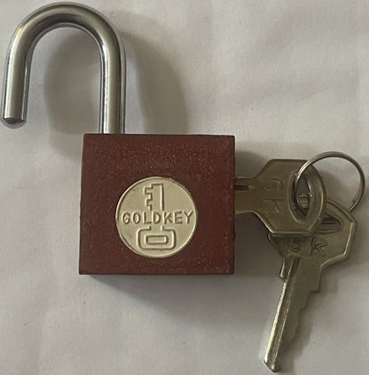 Vintage GoldKey padlock with burgundy body and chrome shackle, shown open with two brass keys beside it on white background