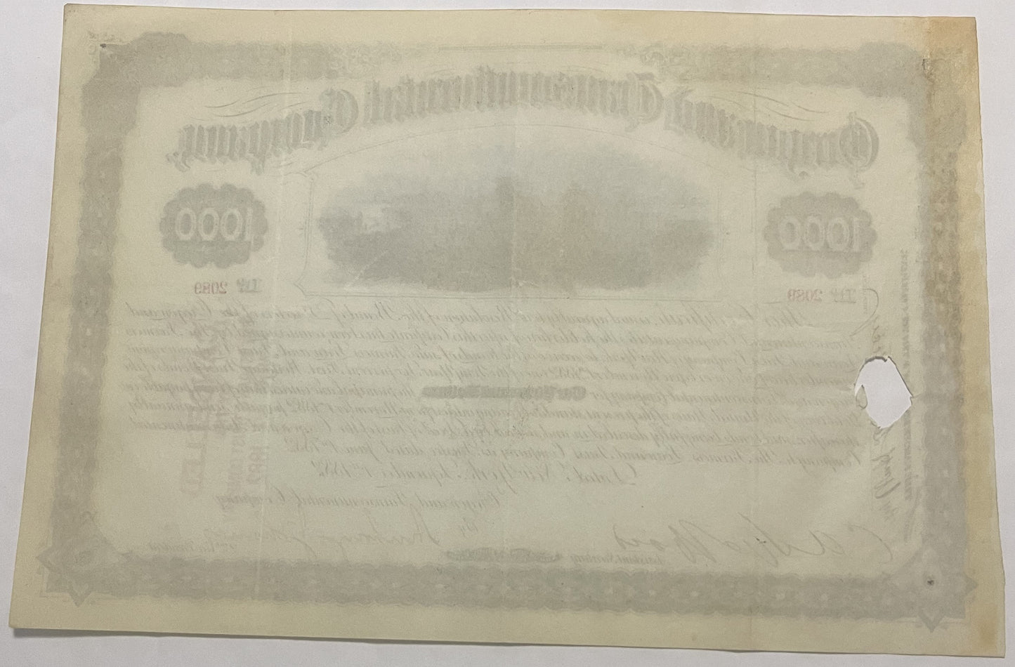 Back of faded 1000 dollar bond certificate with ornamental border, denomination numerals, and illegible printed text on aged 