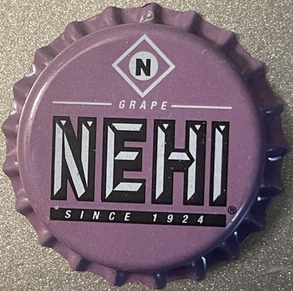 Purple Nehi Grape bottle cap with embossed ridged edges, displaying "GRAPE NEHI SINCE 1924" text and diamond "N" logo
