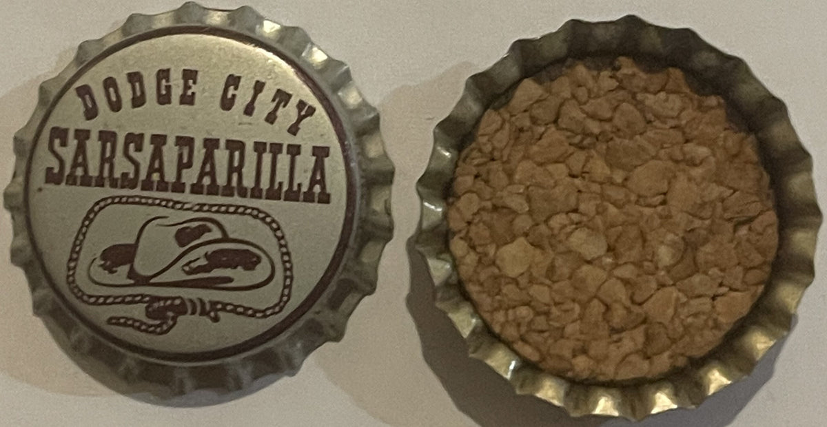 Vintage Dodge City Sarsaparilla bottle cap shown front and back, metal with embossed Western hat design and cork liner
