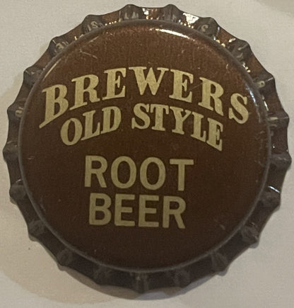 Brown bottle cap with scalloped edges and tan text reading "BREWERS OLD STYLE ROOT BEER," shown flat against a light backgrou