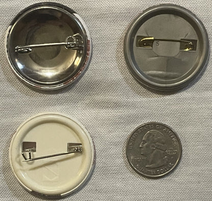 Four views of a circular pin-back button shown front, back, and side angles, with a quarter coin for scale on a textured