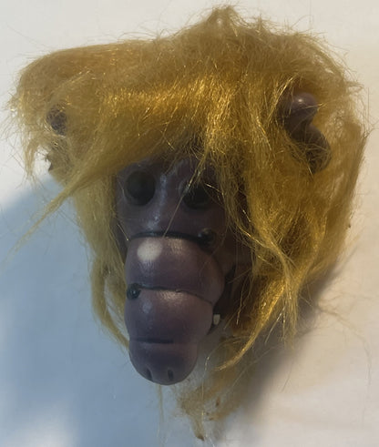 Vintage ALF finger puppet with yellow-green fuzzy hair and dark brown molded face, shown against white background
