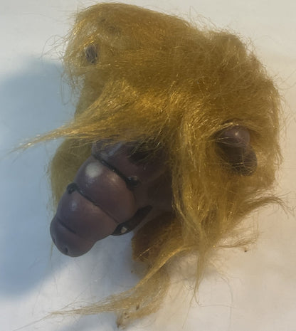 Vintage ALF finger puppet with tan fuzzy fabric body and dark rubber face, shown in profile against white background