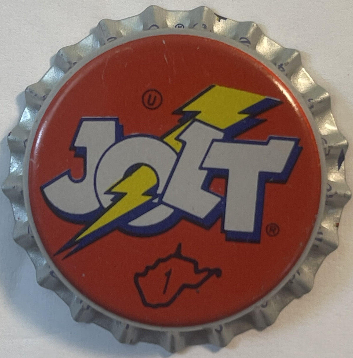 1980s Jolt Cola bottle cap, red-orange face, JOLT with yellow lightning bolt, circled U and West Virginia outline with 1