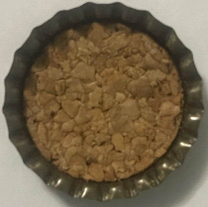 Vintage cork bottle cap with ridged metal edges shown from above on white background, tan cork interior visible