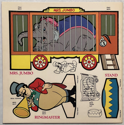 Unfolded vintage Dumbo press-out book page showing Mrs. Jumbo circus wagon, Ringmaster figure, and stand components with fold