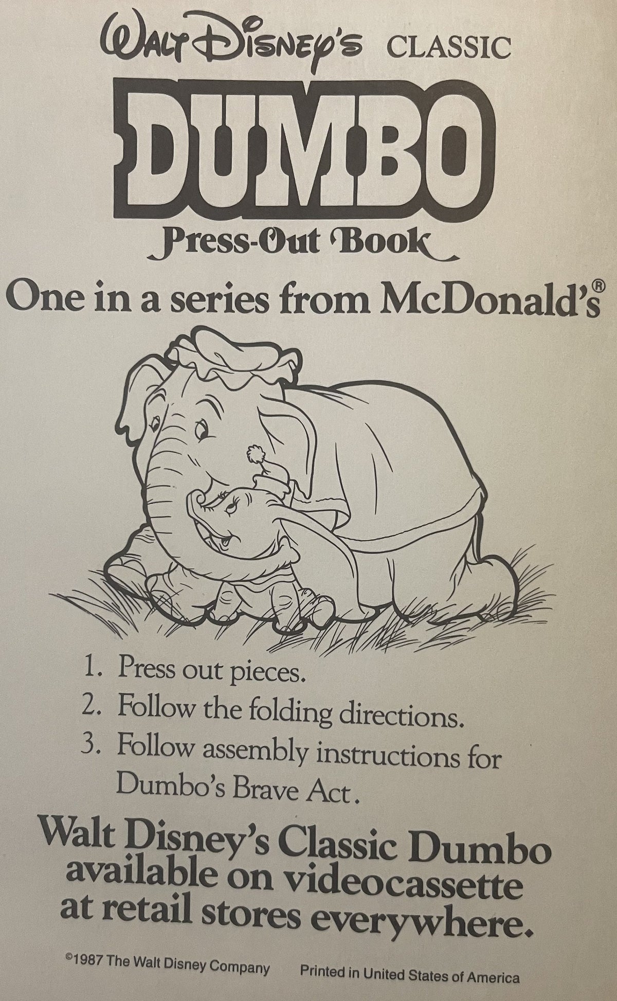 Cover of vintage 1987 Disney Dumbo press-out book from McDonald's, featuring illustrated Dumbo and baby elephant on cream bac