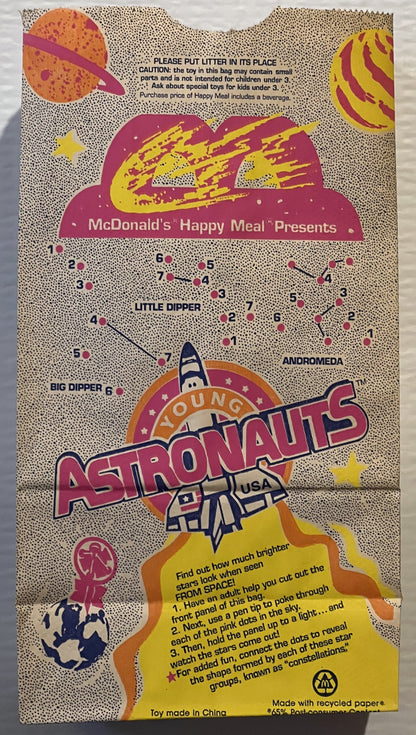 Vintage McDonald's Happy Meal bag featuring Young Astronauts space theme with colorful planets, rocket, and connect-the-dots 