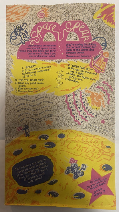 Vintage McDonald's Happy Meal bag with space theme, yellow moon and pink spaceship graphics, printed puzzles