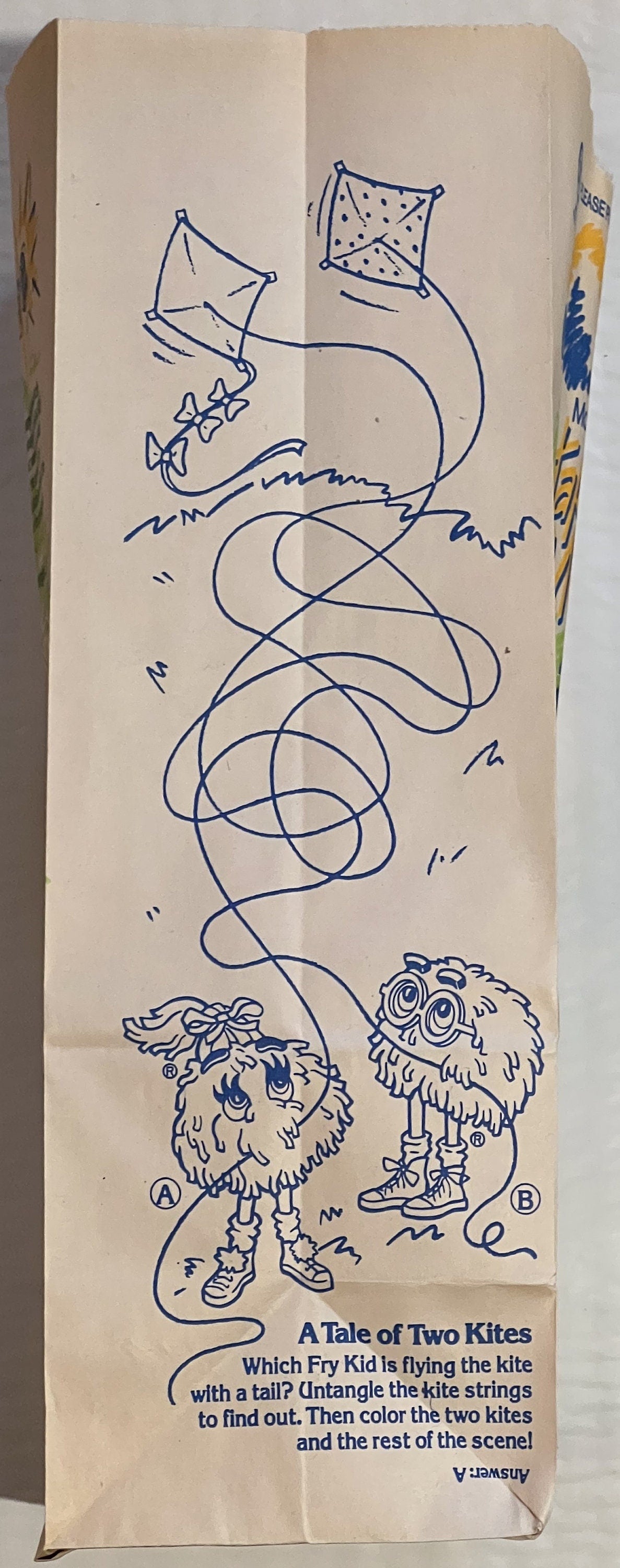 Vintage McDonald's Happy Meal bag with blue ink drawing of two furry characters holding kites, printed activity puzzle titled