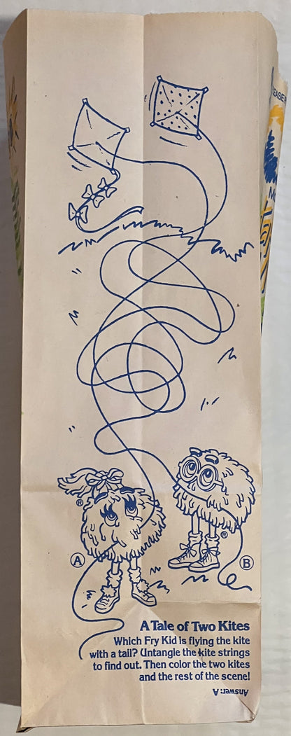 Vintage McDonald's Happy Meal bag with blue ink drawing of two furry characters holding kites, printed activity puzzle titled