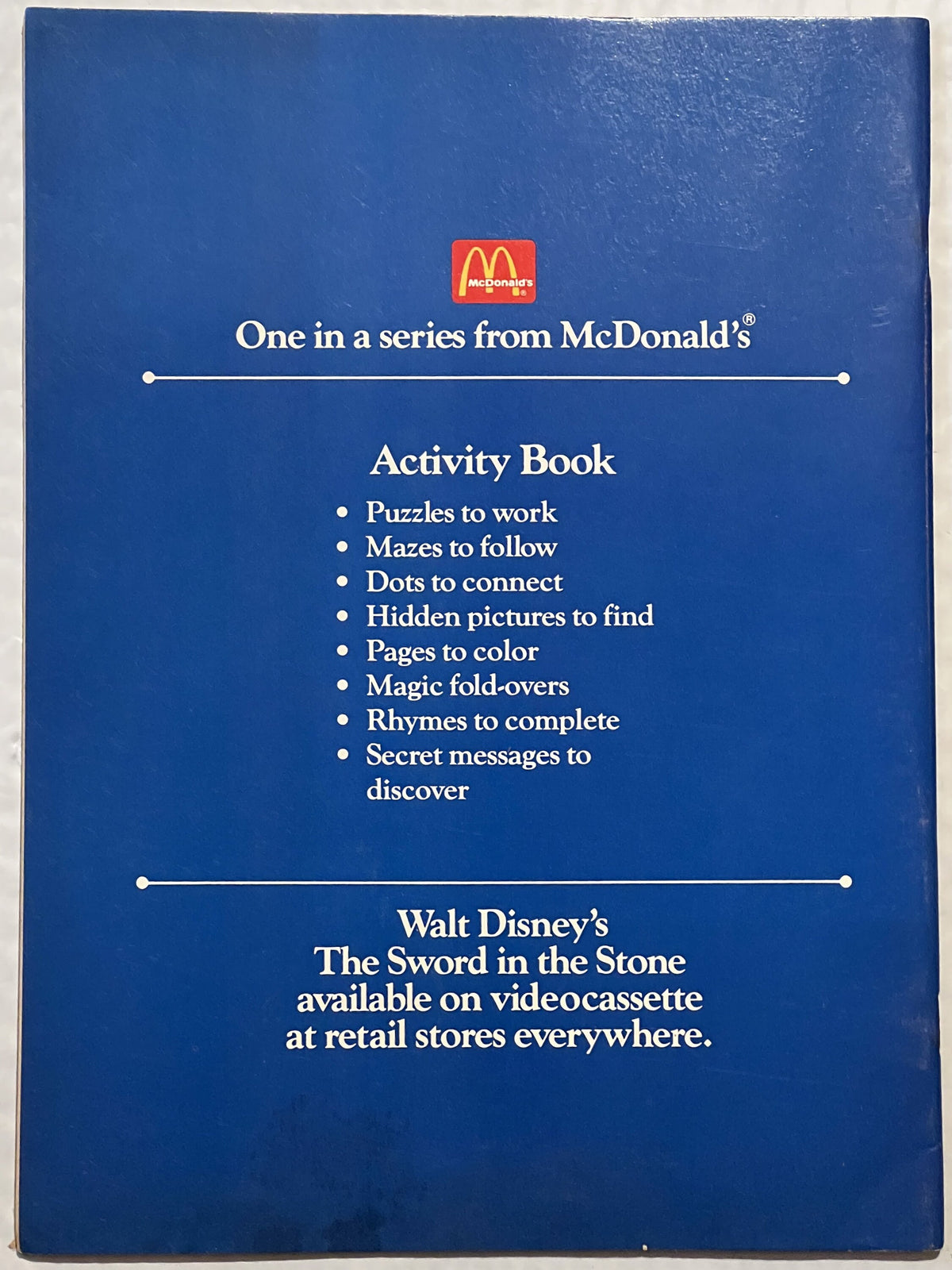 Blue McDonald's Activity Book back cover for Disney's The Sword in the Stone, listing puzzles, mazes, coloring pages and othe