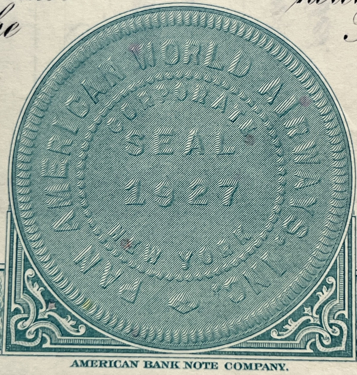 Teal engraved oval vignette from vintage stock certificate by American Bank Note Company, featuring ornate scrollwork corners