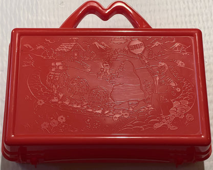 Bright red plastic lunch box with embossed McDonaldland scene featuring characters, houses, and landscape, heart-shaped