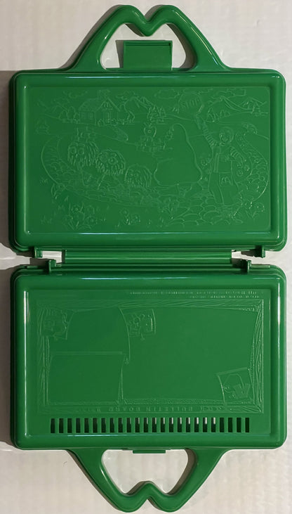 Green McDonald's lunch box opened flat, showing embossed McDonaldland characters on lid and blank interior with ventilation s