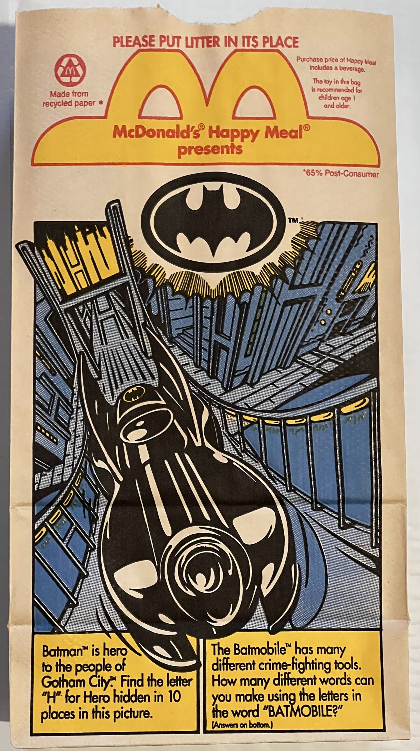 Vintage McDonald's Happy Meal paper bag featuring Batman logo, Batmobile illustration, and activity puzzles on tan recycled p