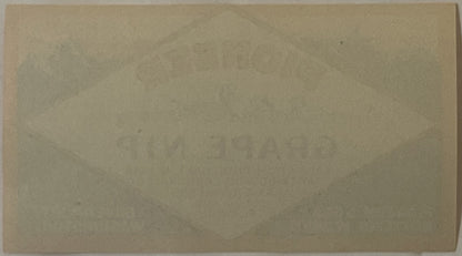 Blank cream-colored vintage label or paper document on tan background, heavily aged with visible discoloration and wear marks
