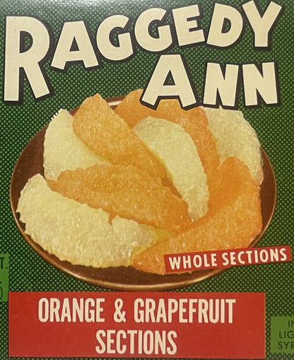 Vintage can label for Raggedy Ann brand orange and grapefruit sections, featuring whole fruit segments in a bowl on green bac