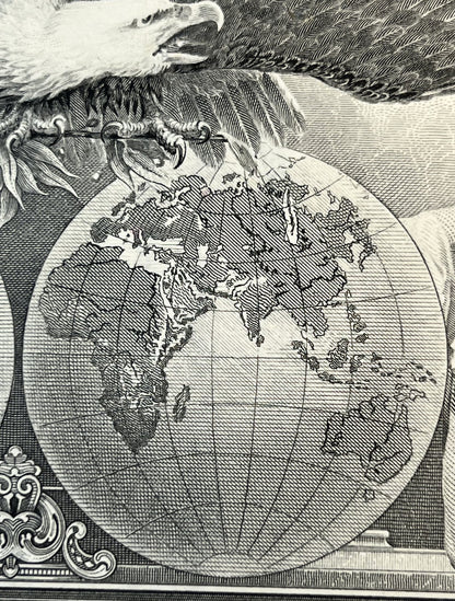 Engraved black and white stock certificate detail showing globe map with eagle and ornamental cartouche in lower left corner