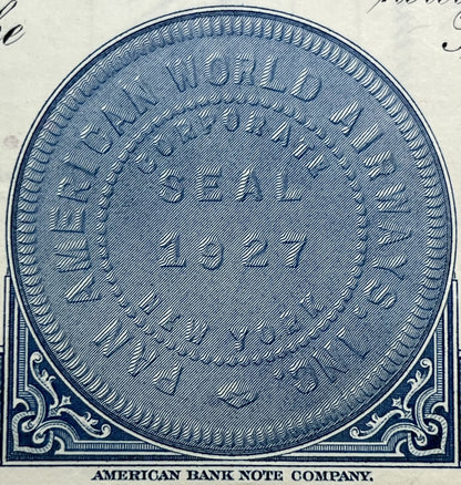 Blue engraved oval vignette from American Bank Note Company stock certificate with ornamental corner scrollwork and diagonal 