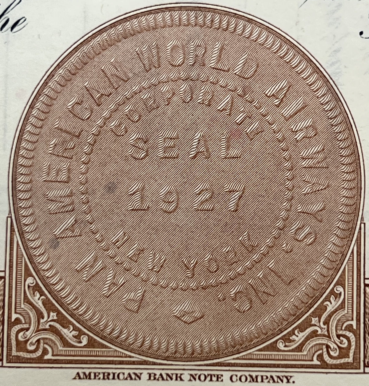 Oval engraving with crosshatch pattern from American Bank Note Company stock certificate, brown ink on cream paper