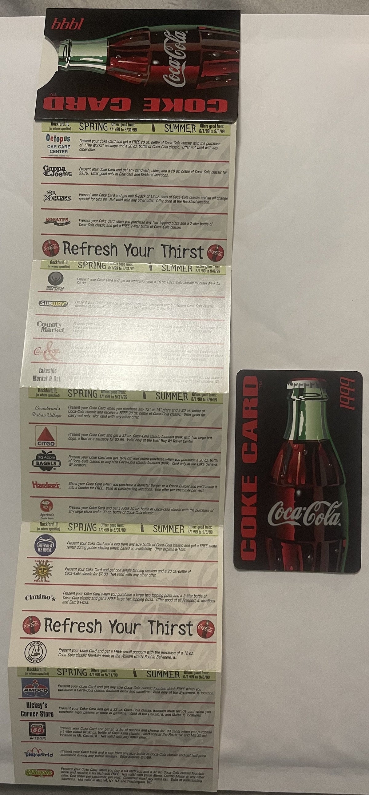 Vintage Coca-Cola promotional credit card with accordion-fold merchant offers displayed flat, showing red bottle imagery and 
