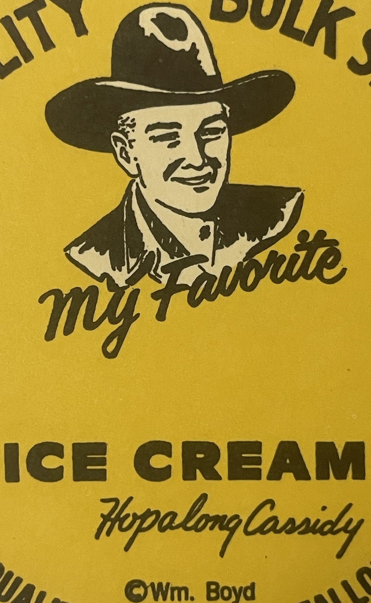 Vintage yellow ice cream sign featuring cowboy in black hat and text "My Favorite Ice Cream" and "Hopalong Cassidy"