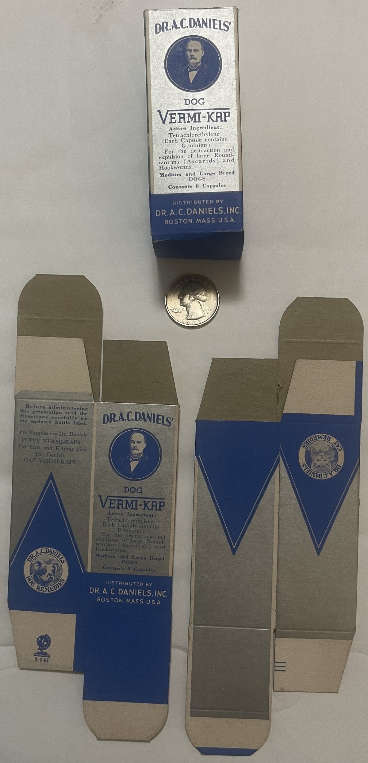 Vintage Dr. A.C. Daniels Dog Vermi-Kap medicine box from Boston with flattened packaging and quarter for scale