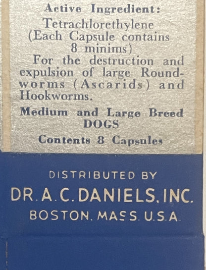 Close-up of vintage dog medicine box label showing tetrachloroethylene capsules distributed by Dr. A.C. Daniels Inc., Boston,