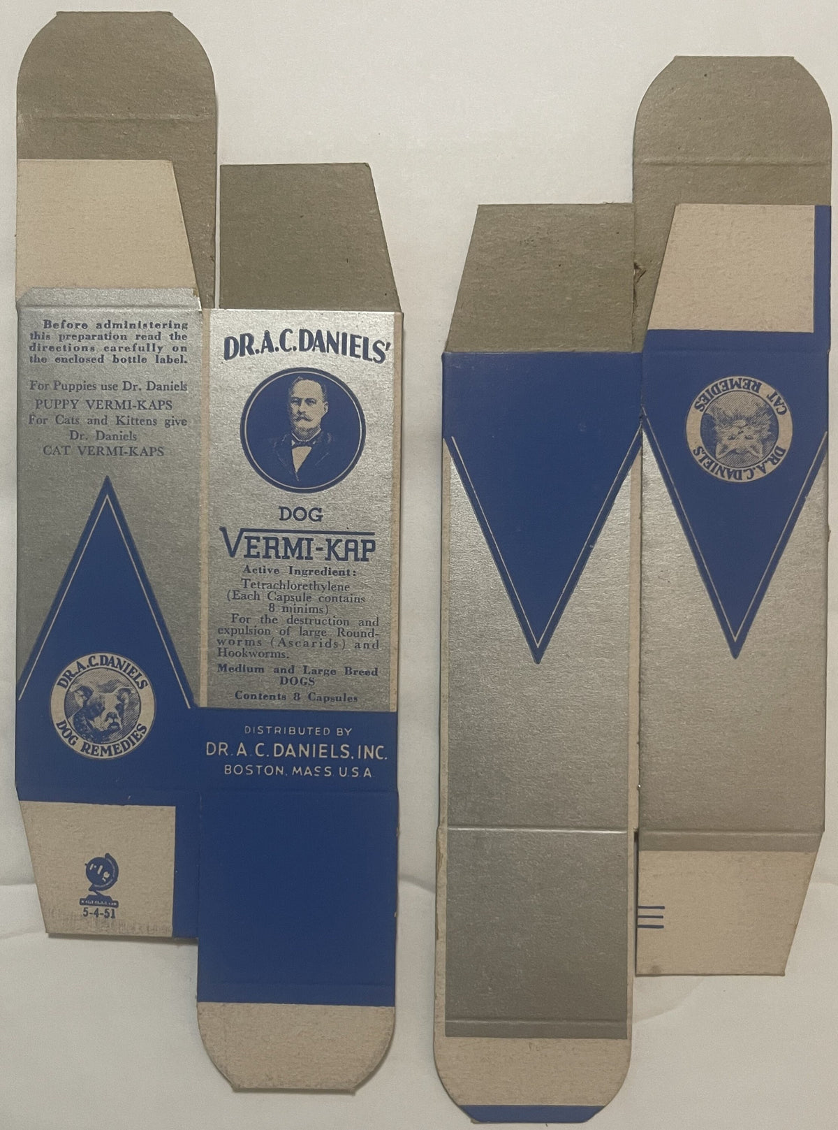 Unfolded vintage veterinary medicine box with blue and cream panels showing Dr. A.C. Daniels portrait and Dog Vermi-Kap brand