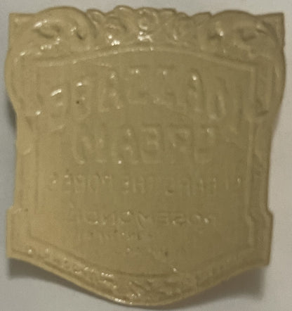 Cream-colored ceramic jar with embossed decorative border at top, viewed from front angle against white background