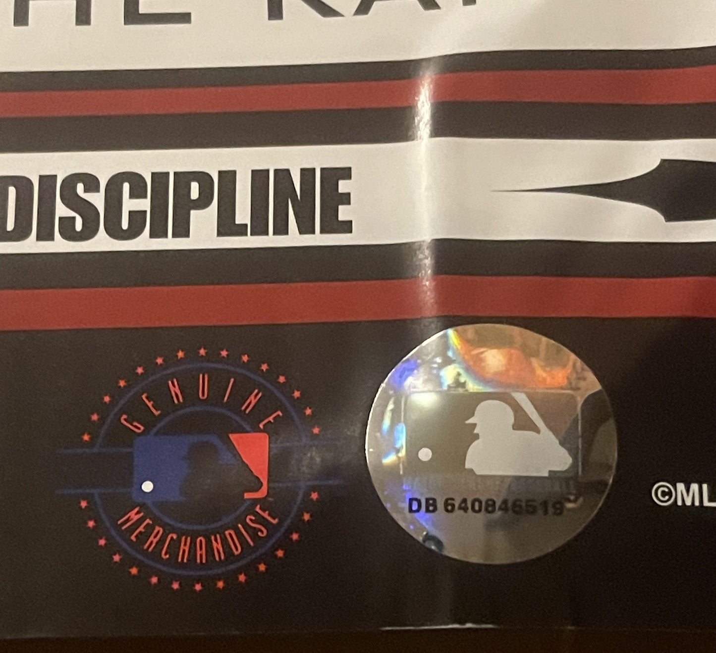 Close-up of MLB Boston Red Sox Dunkin' poster showing "Genuine Merchandise" logo in red and blue with hologram sticker displa