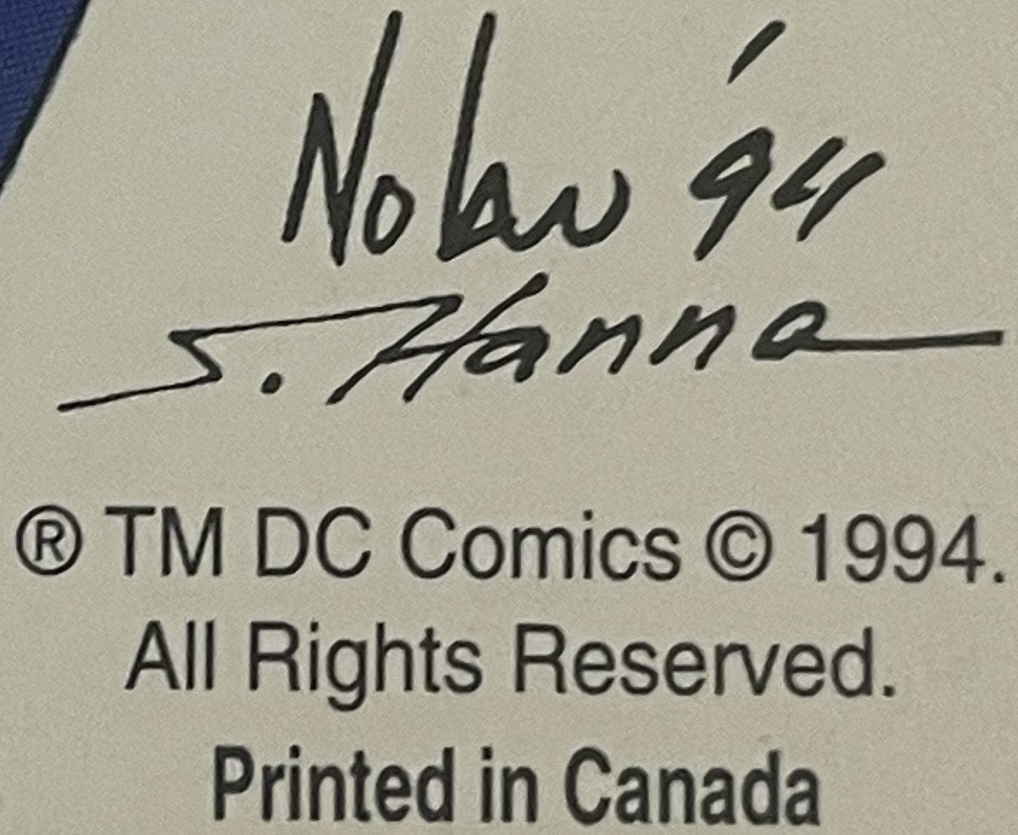 Close-up of postcard back showing handwritten inscription "Nolan 94" and signature "S. Hanna" with DC Comics copyright notice