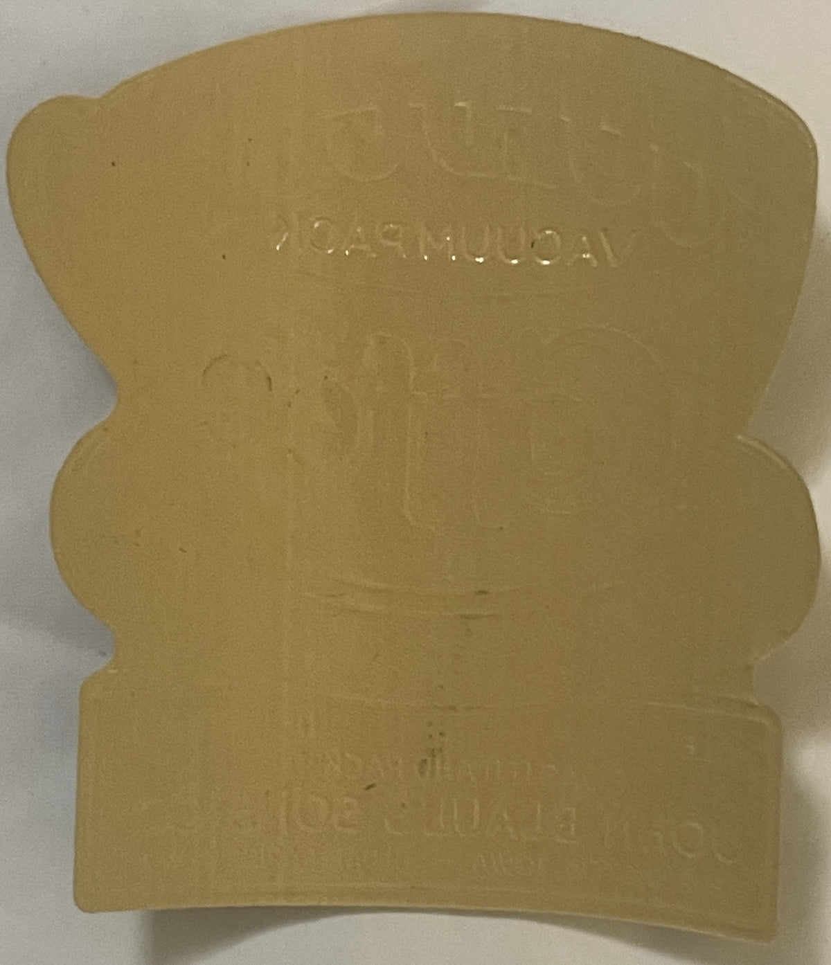 Cream-colored embossed coffee label with wavy edges, text reading "GOLD CUP" and "IOWA VACUUM PACK" visible on tan background