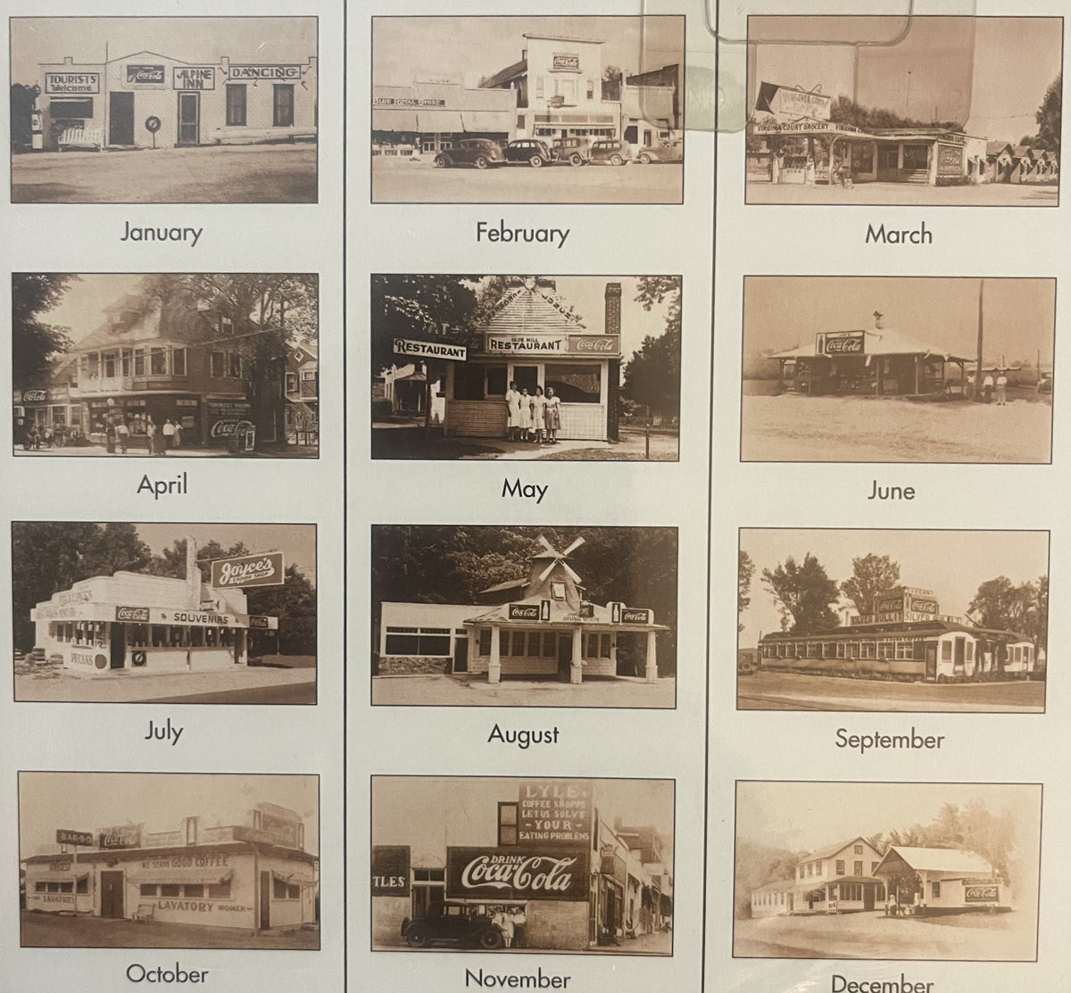 Vintage Coca-Cola calendar with twelve sepia-toned photographs of roadside diners and restaurants, one for each month from Ja