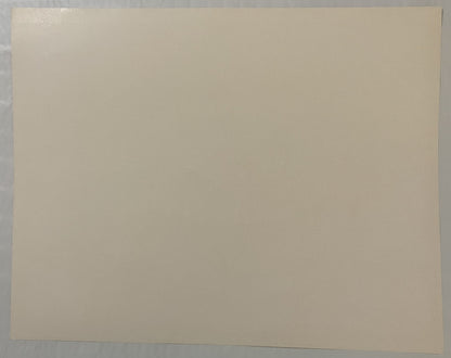 Blank cream-colored paper or print backing photographed flat against gray surface