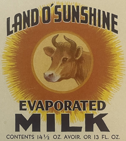 Vintage evaporated milk label with cow's head portrait surrounded by radiating sun rays
