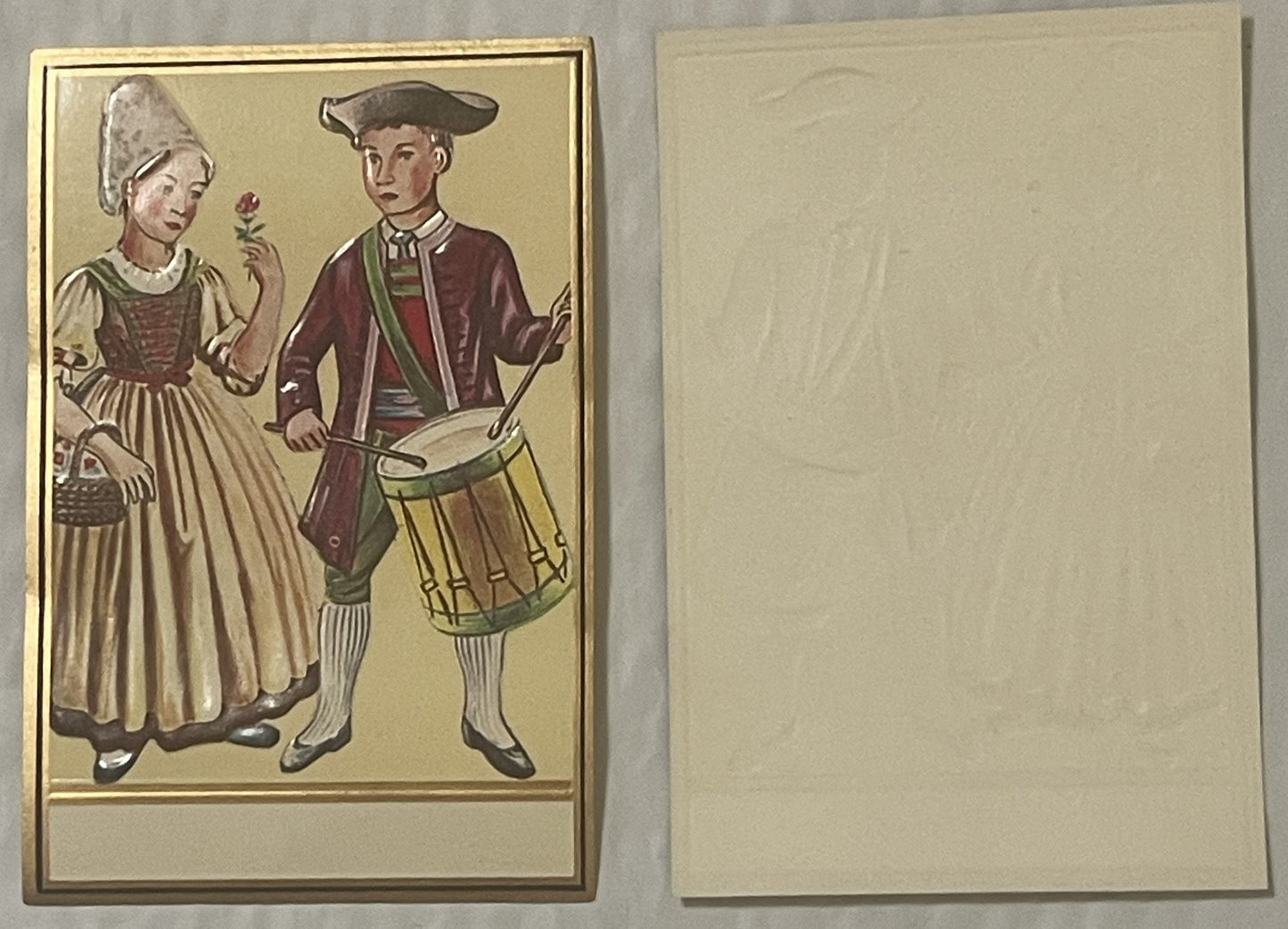 Antique gold-embossed label showing Pennsylvania Dutch couple in colonial dress, man with drum and woman with flower, front a