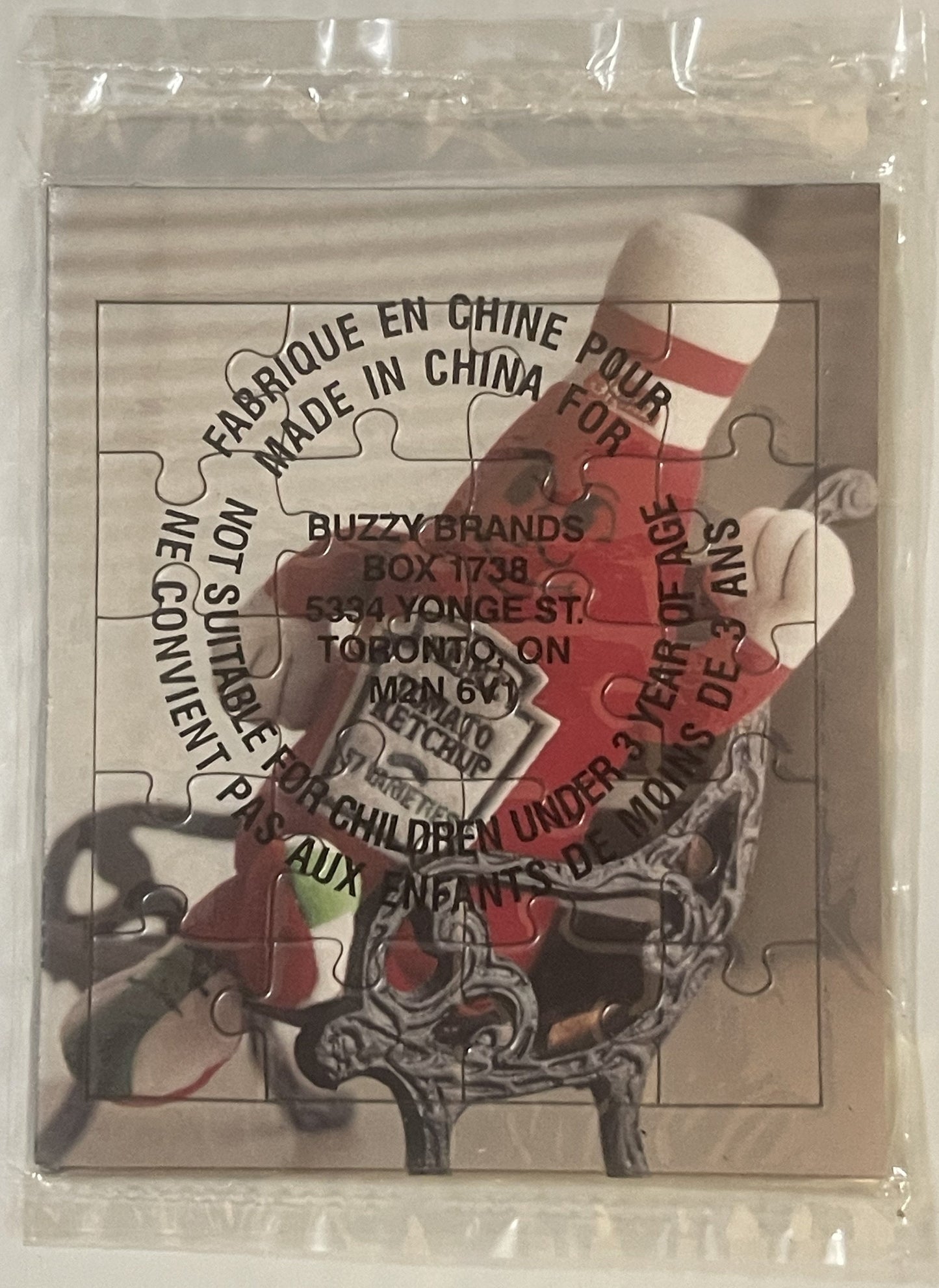 Sealed plastic bag containing a 20-piece jigsaw puzzle featuring a Heinz ketchup bottle mascot with red and white coloring an