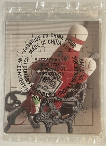 Sealed plastic bag containing a 20-piece jigsaw puzzle featuring a Heinz ketchup bottle mascot with red and white coloring an