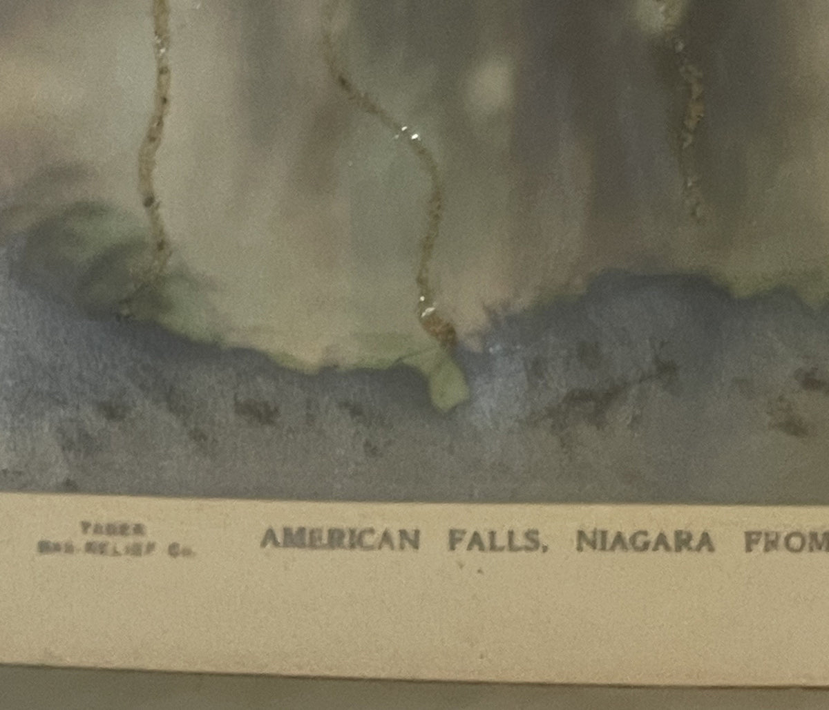 Vintage postcard showing American Falls at Niagara with embossed details and aged cream-colored border, text partially visibl