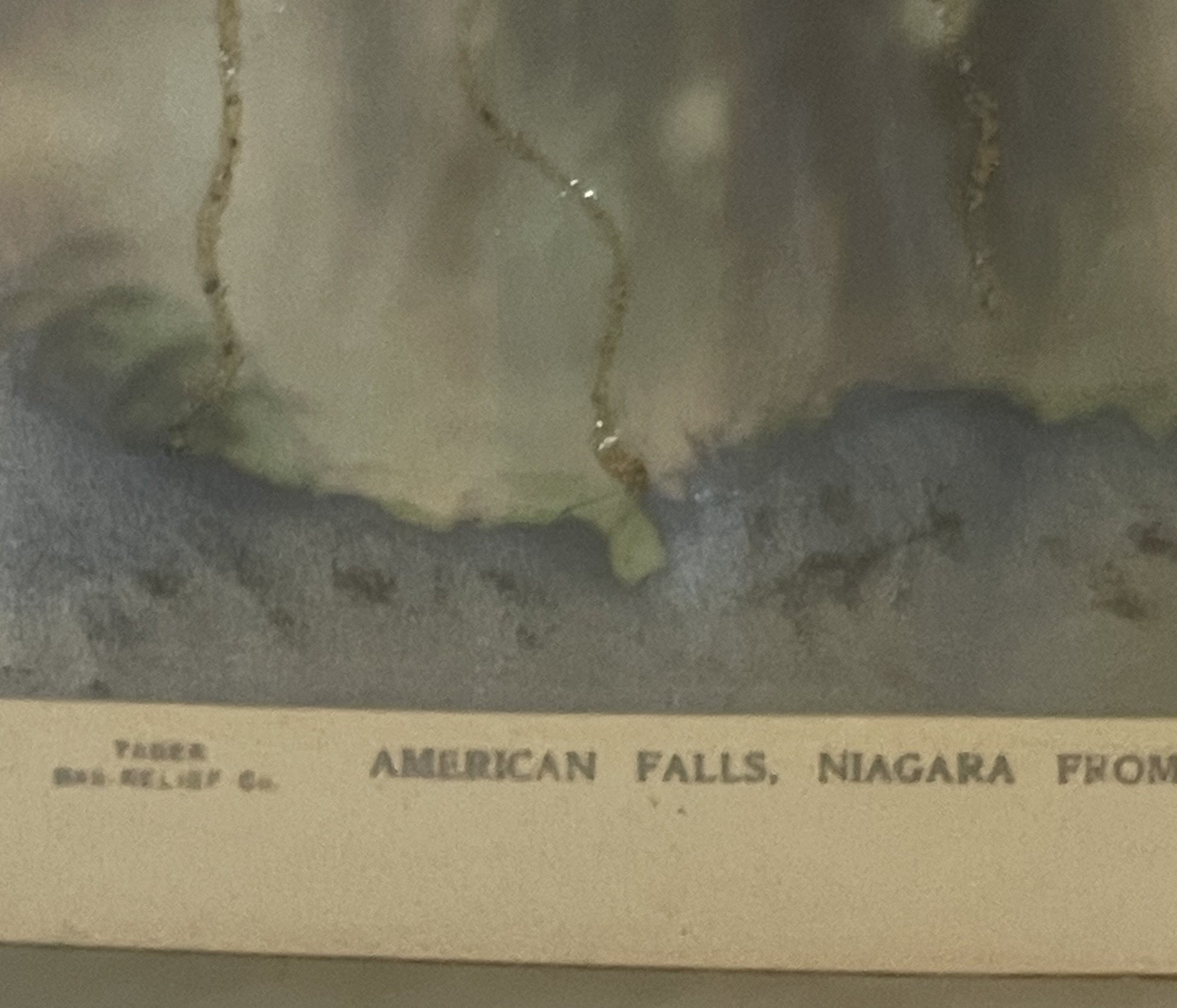Vintage postcard showing American Falls at Niagara with embossed details and aged cream-colored border, text partially visibl