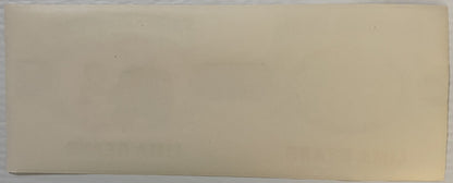 Blank cream-colored vintage label or packaging material photographed flat against neutral background