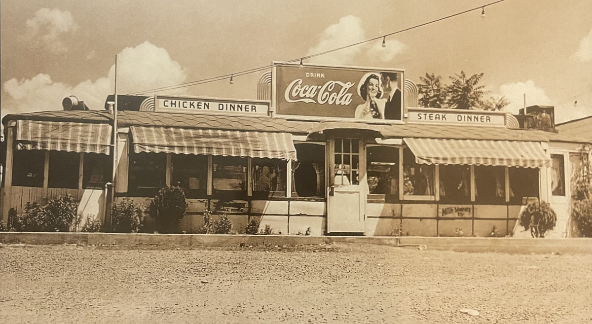 Vintage sepia-toned photograph of a 1940s-50s roadside diner with striped awnings, Coca-Cola signage, and "Chicken Dinner" an