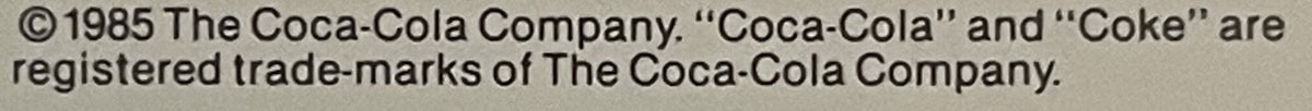Close-up of copyright notice text from 1985 Coca-Cola Company stating "Coca-Cola" and "Coke" are registered