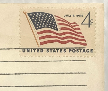 Vintage 4-cent US postage stamp envelope dated July 4, 1959, featuring waving American flag with stars and stripes in red, wh