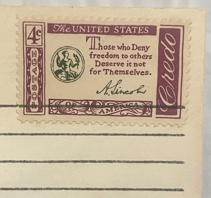Vintage 4-cent stamped envelope with burgundy and cream design featuring Lincoln quote and classical figure medallion, shown 