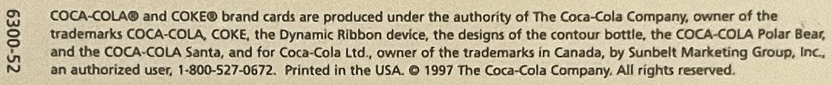 Close-up of copyright text from 1997 Coca-Cola postcard showing trademark and printing information on beige background