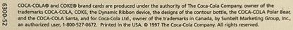 Close-up of copyright text from 1997 Coca-Cola postcard showing trademark and printing information on beige background